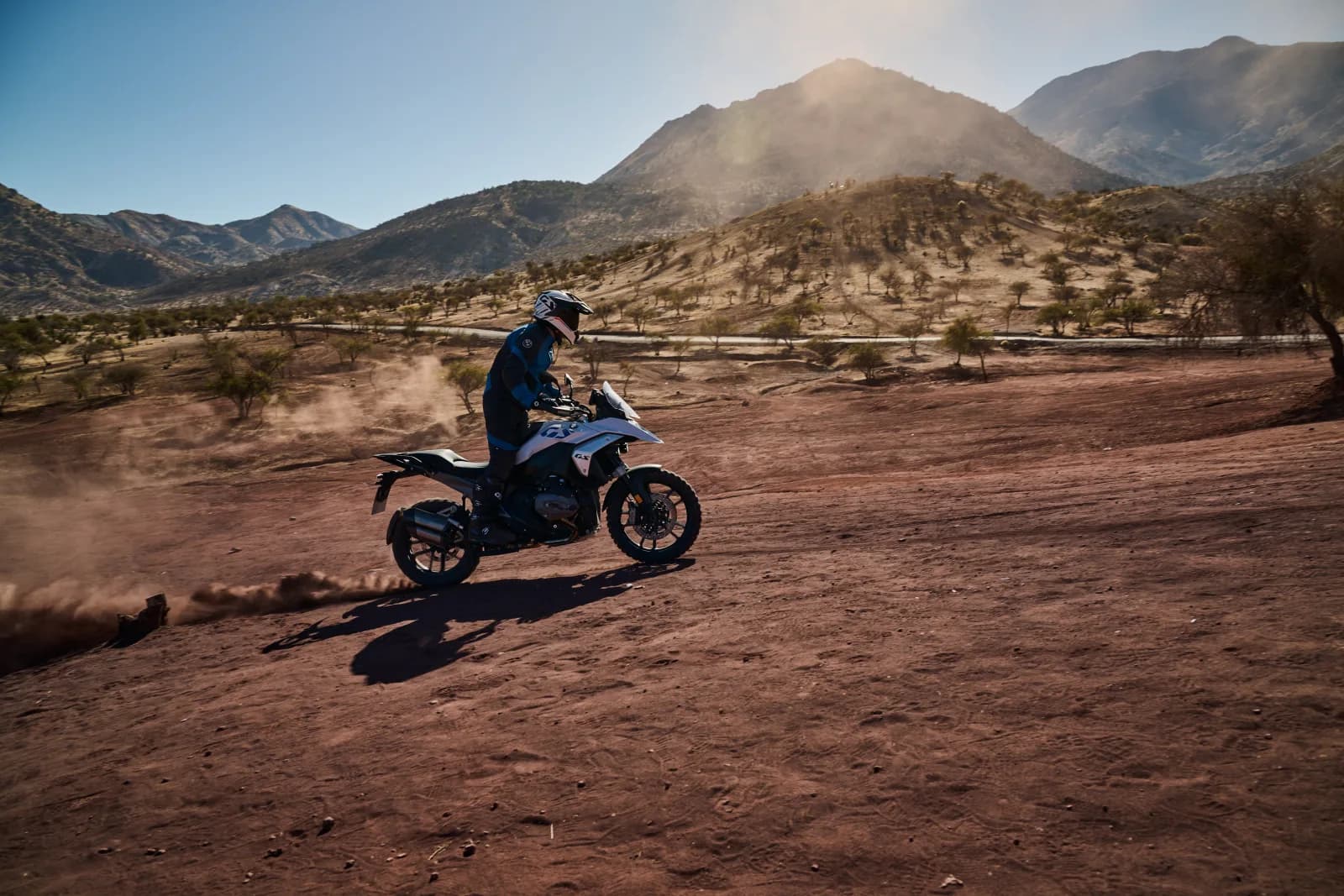 BMW R 1300 GS rider in red desert with mountains